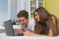 Happy teenager girl and boy watching a laptop Royalty Free Stock Photo