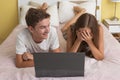 Happy teenager girl and boy watching a laptop Royalty Free Stock Photo