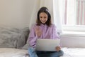 Happy teenager girl talk on video call on laptop