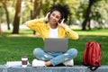 Happy Teenager Girl Using Laptop Computer Wearing Headphones In Park Royalty Free Stock Photo