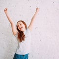 Happy teenager girl on the white background of the wall Royalty Free Stock Photo