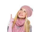 Happy teenager girl in winter hat pointing up on copy space Royalty Free Stock Photo