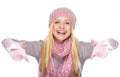 Happy teenager girl in winter hat and scarf pointing down Royalty Free Stock Photo