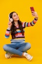 Happy teenager girl 12, 13, 14 years old with smart phone. Hipster teen girl types message on cellphone, enjoys mobile Royalty Free Stock Photo