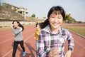 Happy teenager girls running on the track