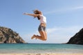 Happy teenager jumping on the beach