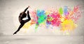 Happy teenager jumping with colorful ink splatter on urban background Royalty Free Stock Photo