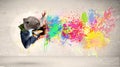 Happy teenager jumping with colorful ink splatter on urban background Royalty Free Stock Photo