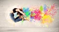 Happy teenager jumping with colorful ink splatter on urban backg Royalty Free Stock Photo