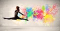 Happy teenager jumping with colorful ink splatter on urban backg Royalty Free Stock Photo