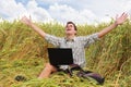 Happy teenager with a laptop in the field. Royalty Free Stock Photo