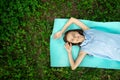 Happy teenager is lying on grass on sunny summer day,girl is resting in park,young beautiful woman in nature is smiling,rejoicing, Royalty Free Stock Photo