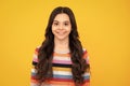 Happy teenager, positive and smiling emotions of teen girl. Children studio portrait on yellow background. Childhood Royalty Free Stock Photo