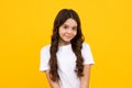 Happy teenager, positive and smiling emotions of teen girl. Children studio portrait on yellow background. Childhood Royalty Free Stock Photo