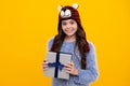 Happy teenager, positive and smiling emotions of teen girl. Funny kid girl in winter wear holding gift boxes celebrating Royalty Free Stock Photo