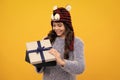 Happy teenager, positive and smiling emotions of teen girl. Funny kid girl in winter wear holding gift boxes celebrating Royalty Free Stock Photo