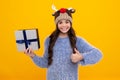 Happy teenager, positive and smiling emotions of teen girl. Funny kid girl in winter wear holding gift boxes celebrating Royalty Free Stock Photo