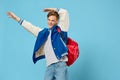 happy teenager rejoices jumping with backpack