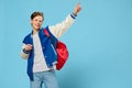 happy teenager rejoices jumping with backpack