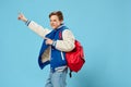 happy teenager rejoices jumping with backpack