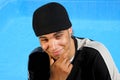 Happy teenager sitting at swimming pool