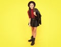 Happy teenager smiling girl. Teenager child girl casual leather skirt posing isolated on yellow background in studio Royalty Free Stock Photo