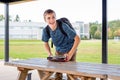 Happy teenager studying outdoors at a picnic table. Royalty Free Stock Photo