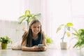 A happy teenager is texting on a mobile phone, lying on the floor in the living room. Modern technologies, online Royalty Free Stock Photo