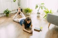 A happy teenager is texting on a mobile phone, lying on the floor in the living room. Modern technologies, online Royalty Free Stock Photo