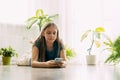 A happy teenager is texting on a mobile phone, lying on the floor in the living room. Modern technologies, online Royalty Free Stock Photo