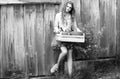 Happy teenager, young teen girl holding wooden crate with pots from farm. Woman planting flowers in pot. Royalty Free Stock Photo