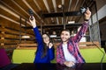 Happy teenagers playing video game with control pad in living room Royalty Free Stock Photo