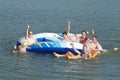 Happy teenagers on a raft in a lake