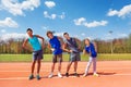 Happy teens doing side bending exercises outdoors Royalty Free Stock Photo