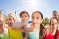 Happy teens in front of volleyball net, close-up