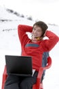 Happy teens with laptop in winter mountains