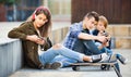 Happy teens playing on smarthphones