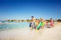 Happy teens running along sandy beach in summer Royalty Free Stock Photo