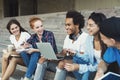 Happy teens talking outdoors, spending free time together