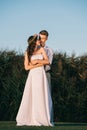 happy tender young wedding couple embracing and smiling