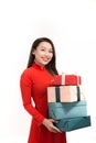 Happy Tet holiday chinese new year. Smile asian woman in ao dai holding new year gift box present Royalty Free Stock Photo