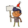 happy textured cartoon of a man with sign wearing santa hat