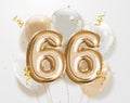 Happy 66th birthday gold foil balloon greeting background.