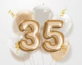 Happy 35th birthday gold foil balloon greeting background.