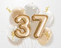 Happy 37th birthday gold foil balloon greeting background.