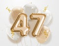 Happy 47th birthday gold foil balloon greeting background. Royalty Free Stock Photo