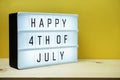 Happy 4th of July light Box with space copy on yellow background Royalty Free Stock Photo