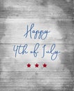 Happy 4th Of July Sign In Blue Letters With Red Stars On Wood Background