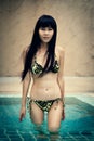 Happy thai female enjoying in swimming pool