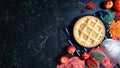 Thanksgiving apple and pumpkin pies on dark marble background.